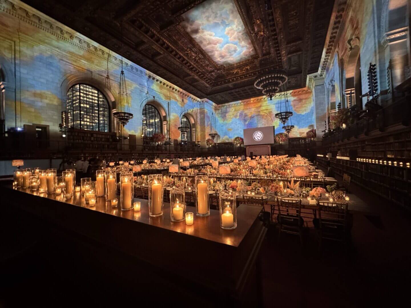 Elegant library event with candlelit tables.